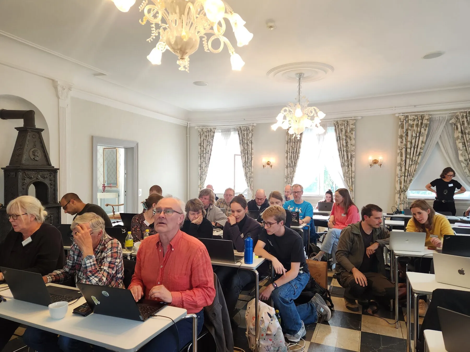 Workshop participants working at laptops in a bright room at the University of Oslo
